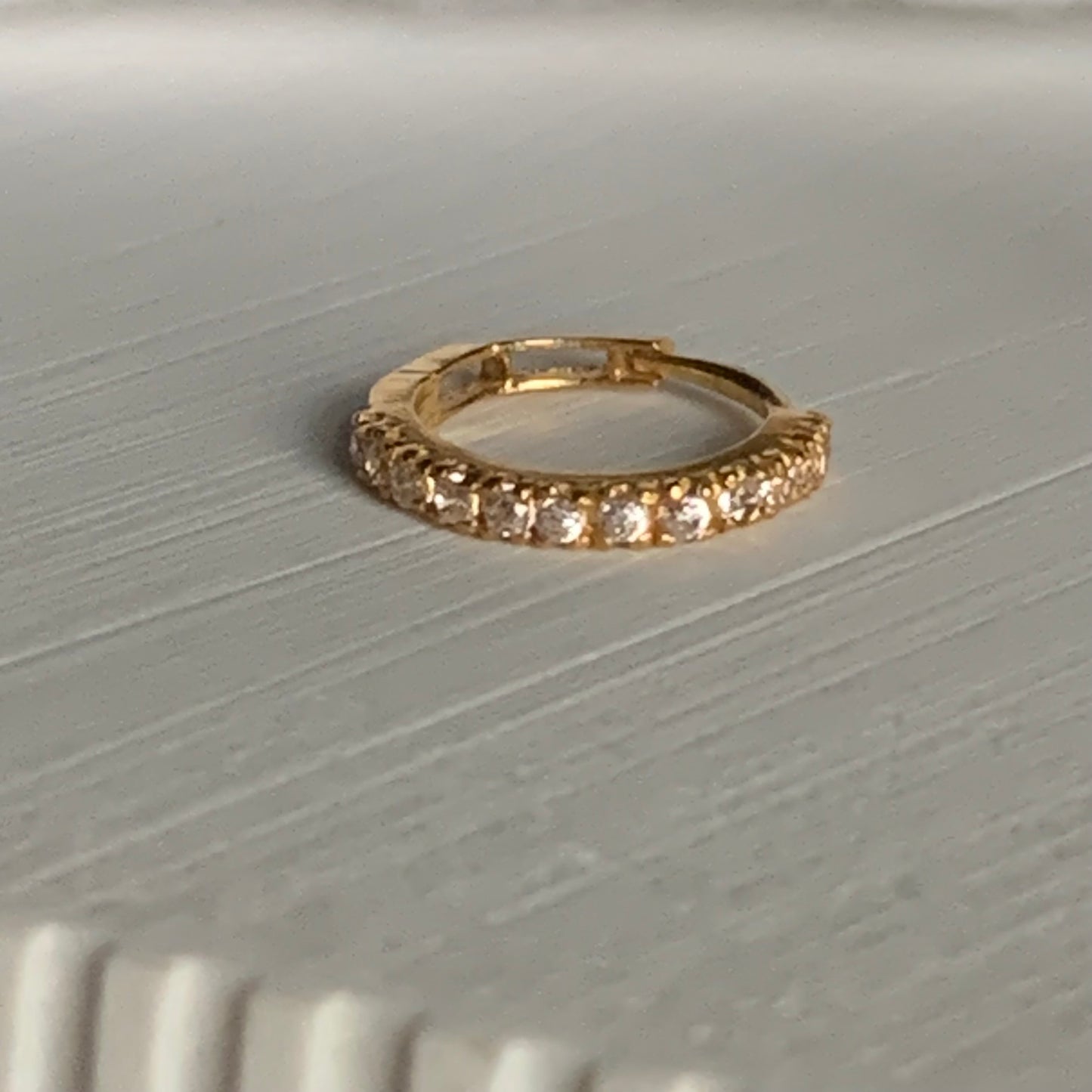 18k gold hoop encrusted with cubic zirconia stones