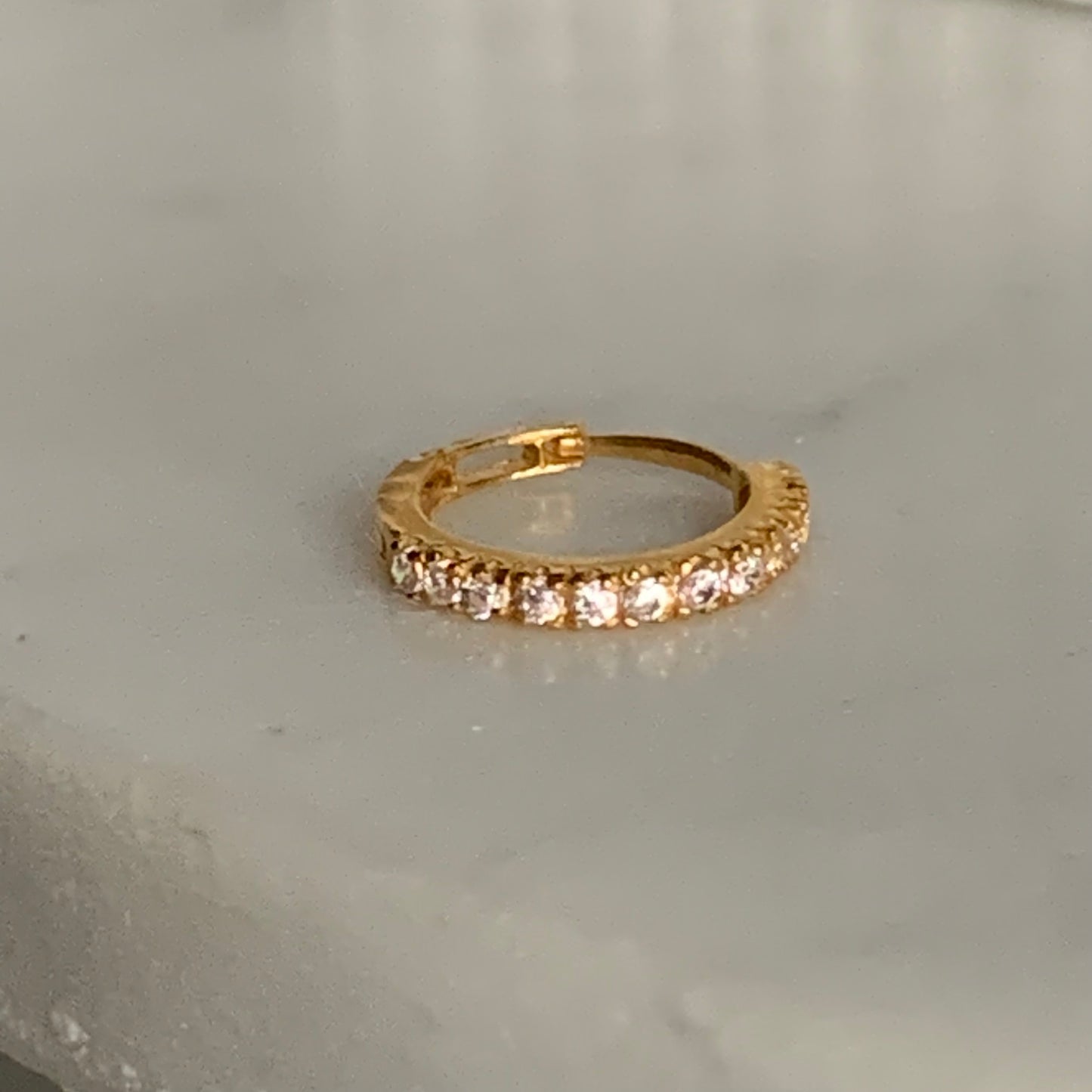 18k gold hoop encrusted with cubic zirconia stones
