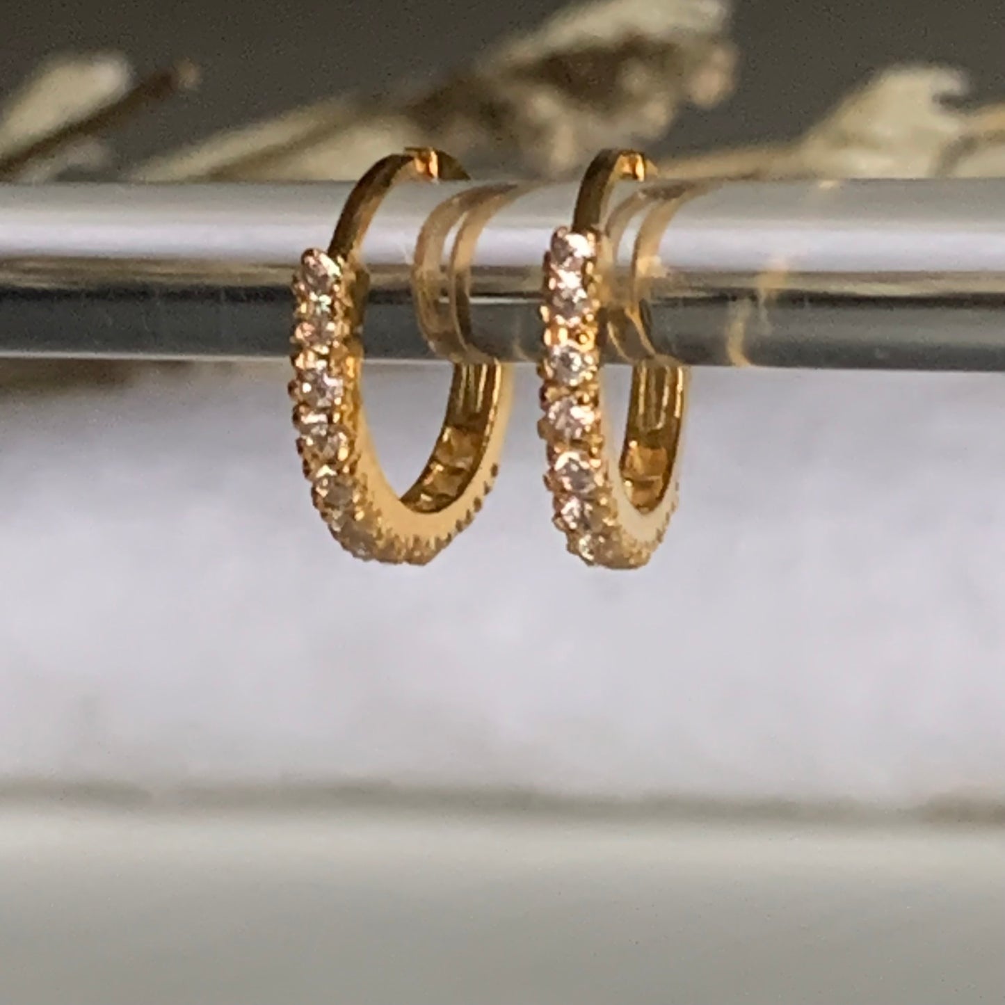 18k gold hoop encrusted with cubic zirconia stones