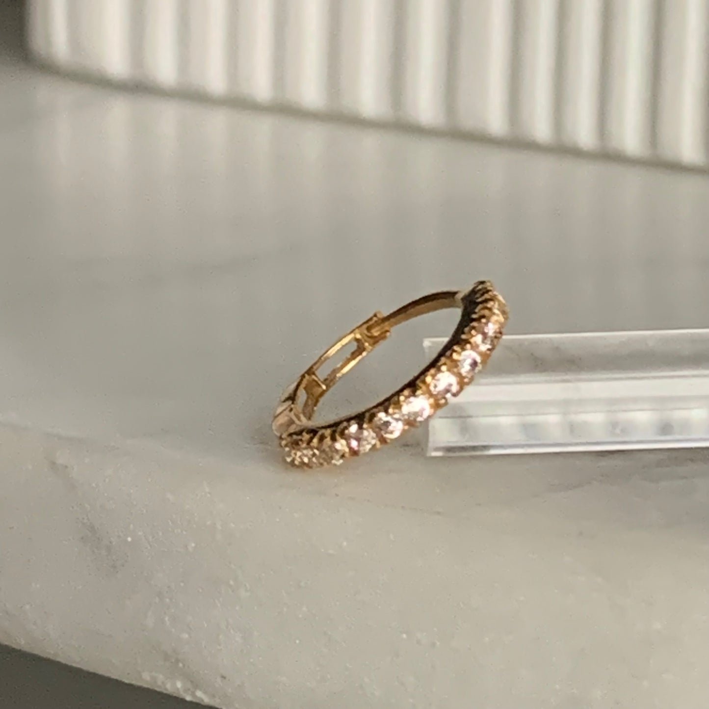 18k gold hoop encrusted with cubic zirconia stones